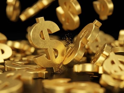 Golden three-dimensional dollar signs falling and piling up against a black background